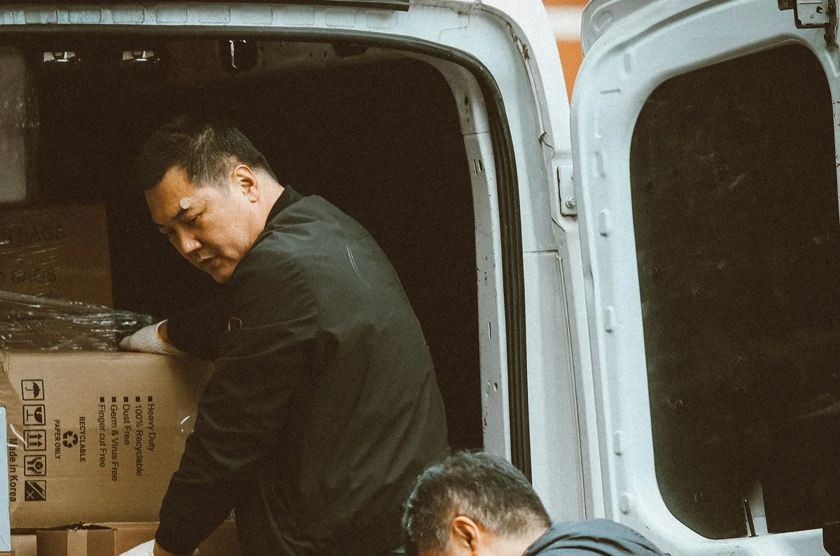 A.R. Gameson delivery van being loaded with packages before a route out of station DJX4